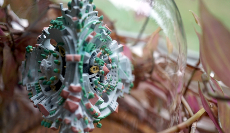 Tetrahedral Planetoid 3D print in bell jar. Classical pagoda face on the left, novel bridge face on the right.